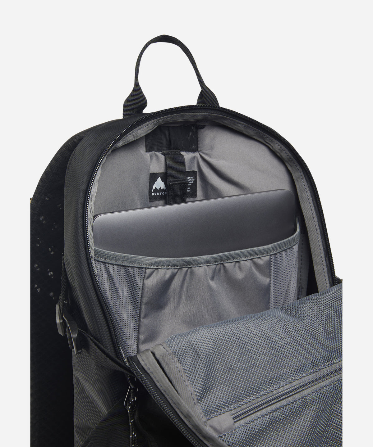 An open black and gray backpack showing its interior compartments, including a laptop sleeve, mesh pocket, and a visible Mountaineering brand tag.