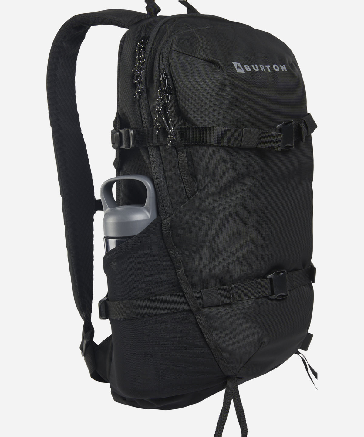 A black Burton backpack shown from a three-quarter side view, featuring a side pocket holding a gray water bottle, adjustable straps, and the Burton logo on the upper right side, set against a plain light gray background.